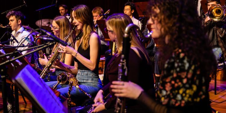 Big Band saxophones and clarinets performing in Milton Concert Hall