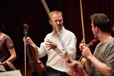 Matthew Jones teaching violin to a student 